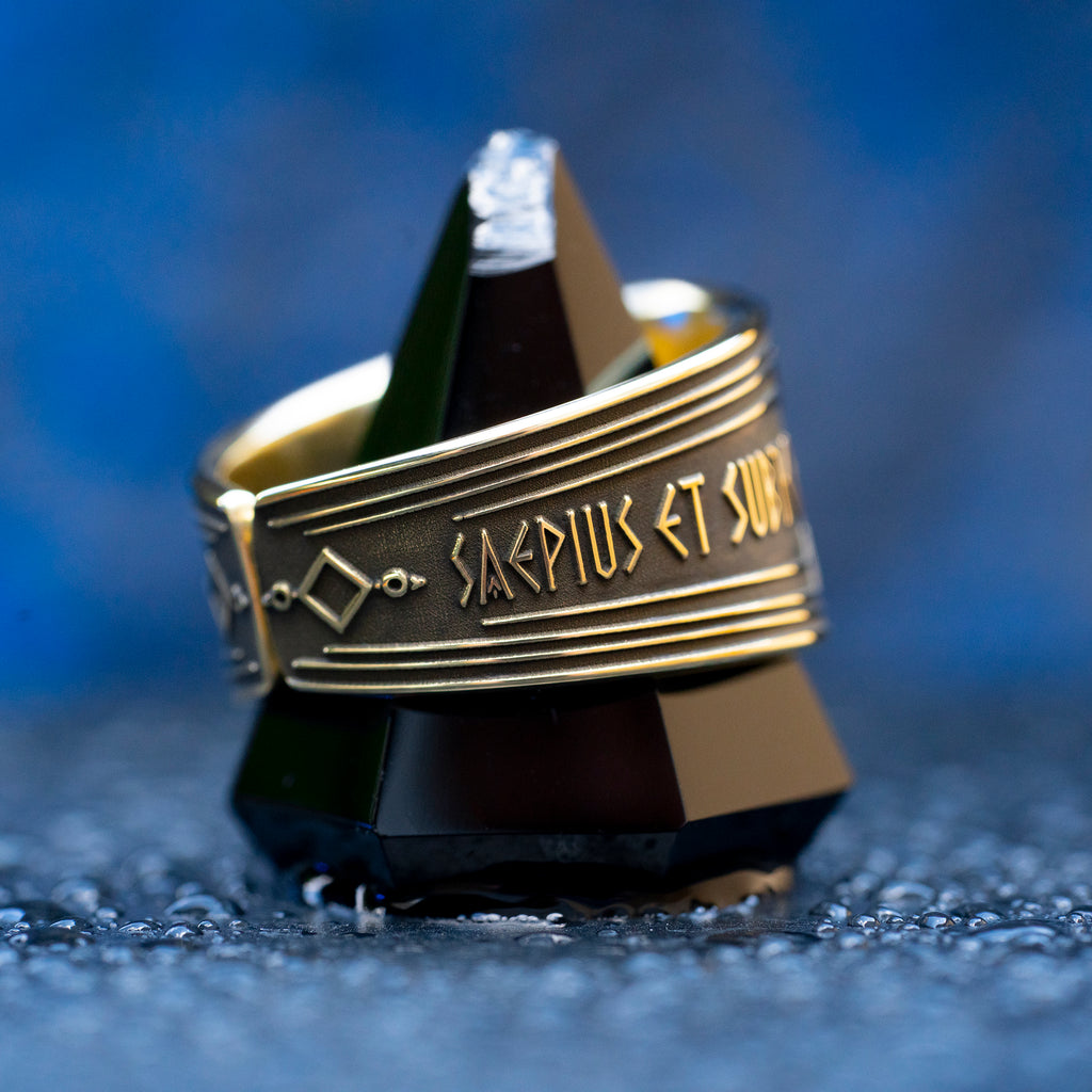 Abracadabra ring with diminishing triangle inscription, Latin spell phrases, ancient healing charm, and protection symbolism