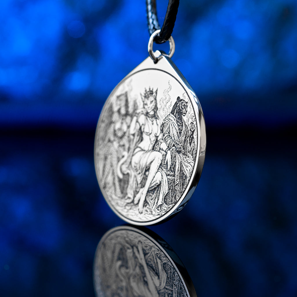 Feline Goetic Trinity pendant featuring detailed engravings of Sitri, Ose and Beleth as feline demons. Silver-tone occult necklace with Ars Goetia artwork on a black cord against a deep blue background.