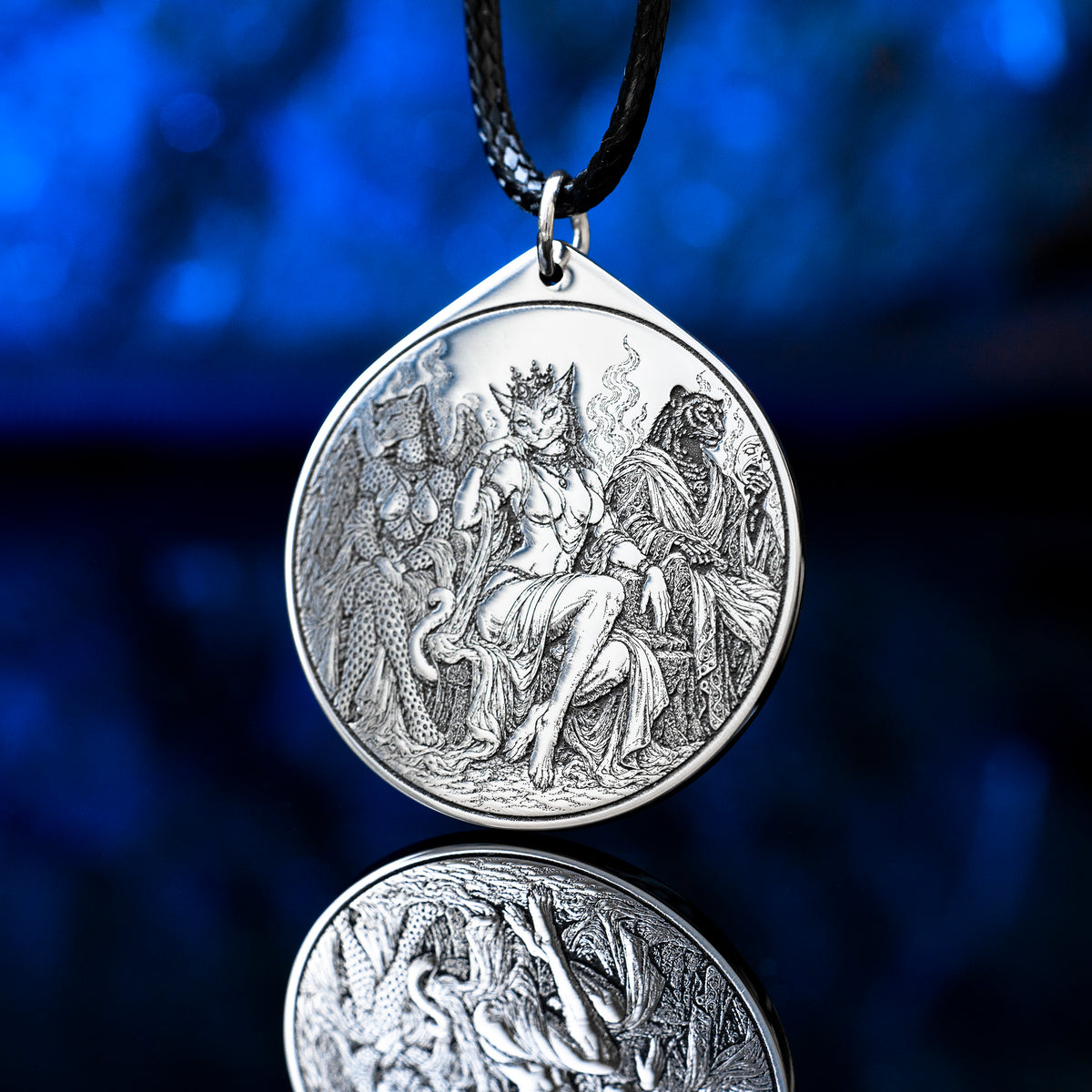 Feline Goetic Trinity pendant featuring detailed engravings of Sitri, Ose and Beleth as feline demons. Silver-tone occult necklace with Ars Goetia artwork on a black cord against a deep blue background.