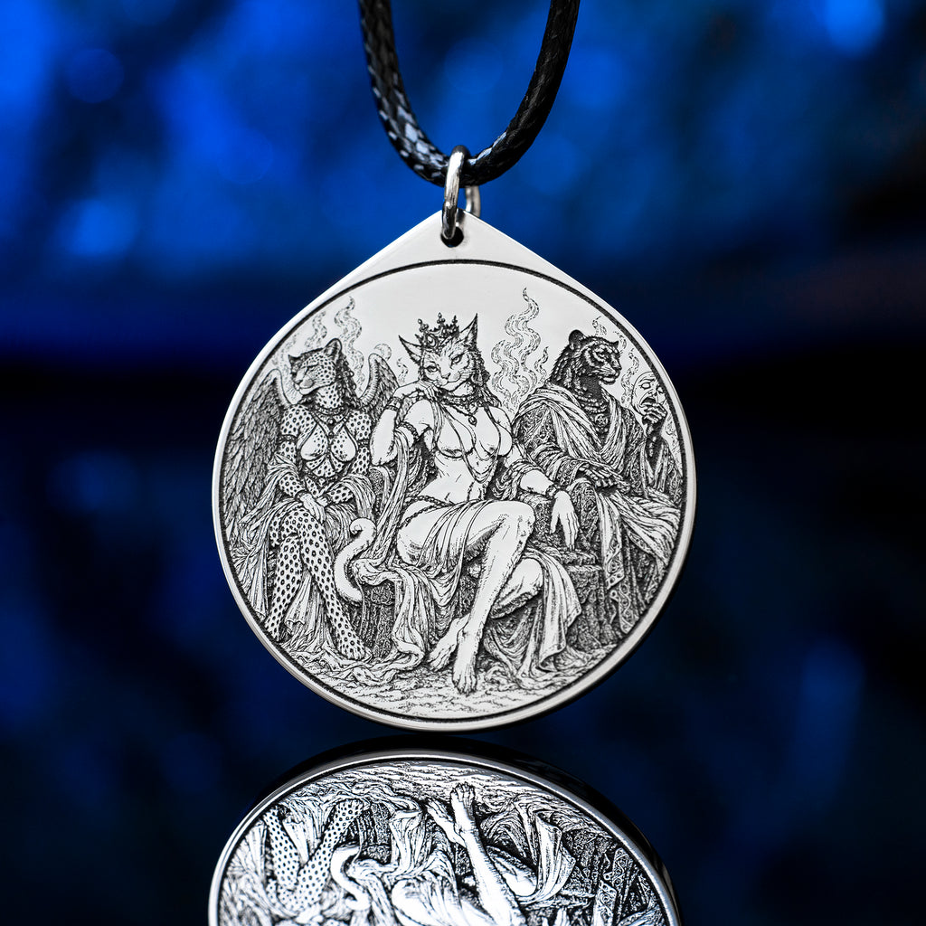 Feline Goetic Trinity pendant featuring detailed engravings of Sitri, Ose and Beleth as feline demons. Silver-tone occult necklace with Ars Goetia artwork on a black cord against a deep blue background.