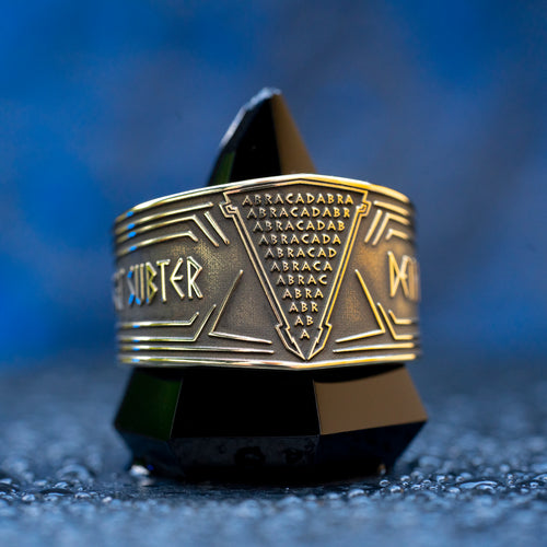 Abracadabra ring with diminishing triangle inscription, Latin spell phrases, ancient healing charm, and protection symbolism