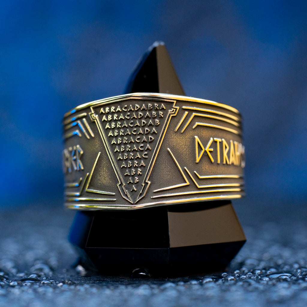 Abracadabra ring with diminishing triangle inscription, Latin spell phrases, ancient healing charm, and protection symbolism