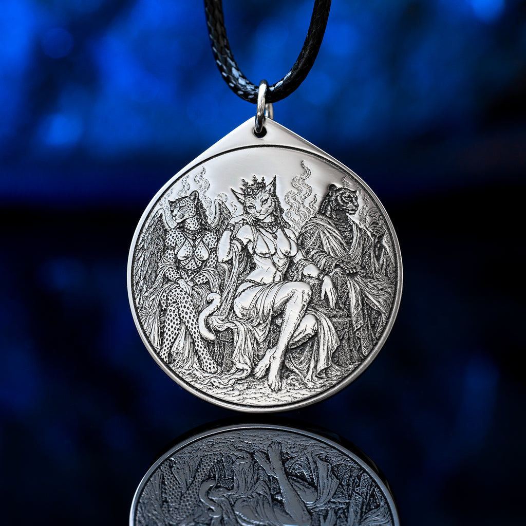 Feline Goetic Trinity pendant featuring detailed engravings of Sitri, Ose and Beleth as feline demons. Silver-tone occult necklace with Ars Goetia artwork on a black cord against a deep blue background.