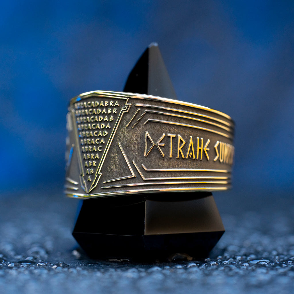 Abracadabra ring with diminishing triangle inscription, Latin spell phrases, ancient healing charm, and protection symbolism