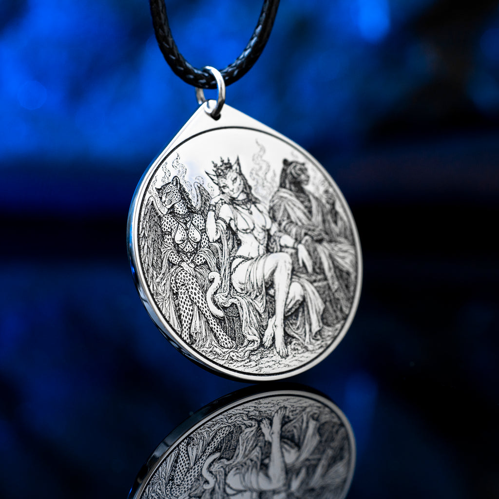 Feline Goetic Trinity pendant featuring detailed engravings of Sitri, Ose and Beleth as feline demons. Silver-tone occult necklace with Ars Goetia artwork on a black cord against a deep blue background.