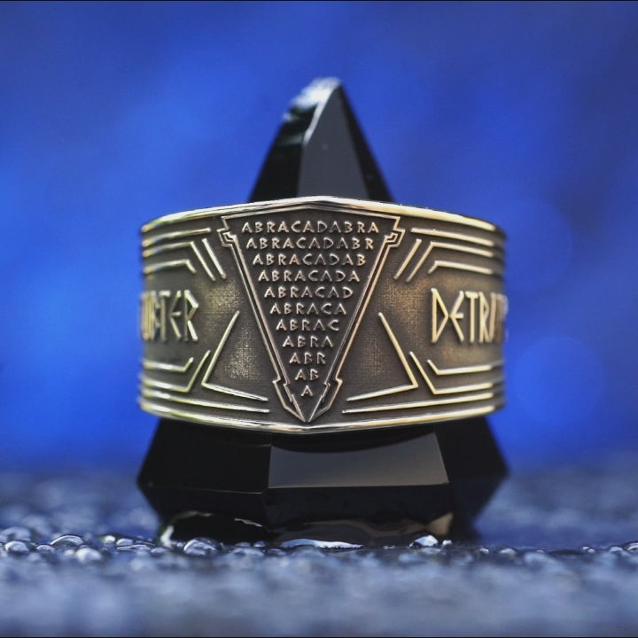 Abracadabra ring with diminishing triangle inscription, Latin spell phrases, ancient healing charm, and protection symbolism